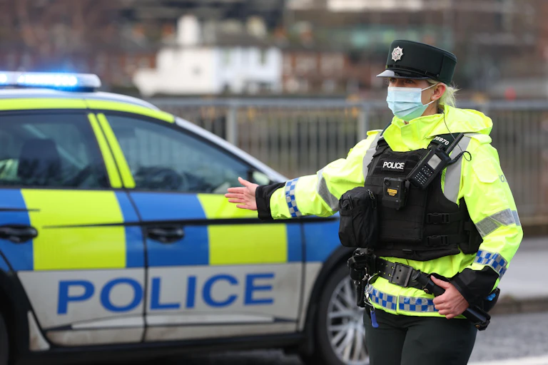 A police officer directing traffic in Belfast.