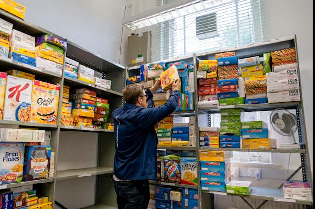 Man stacking cereal boxes on shelves