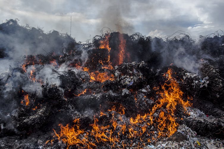 Pile of plastic waste burning.