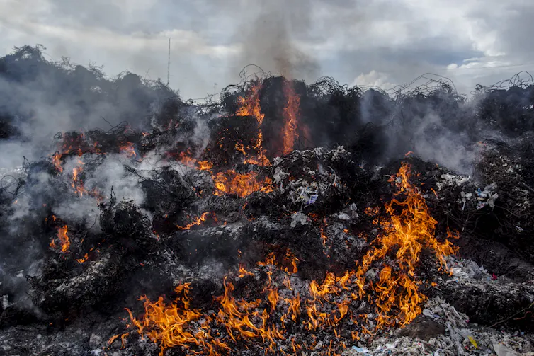 Pile of plastic waste burning.