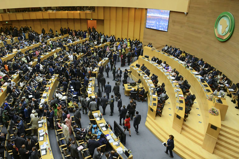 Men and women mingling in a plenary hall.