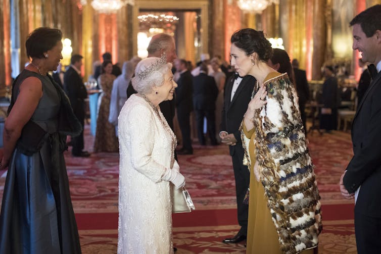 The queen and Jacinda Ardern who is wearing a traditional MÄ&#129;ori cloak or