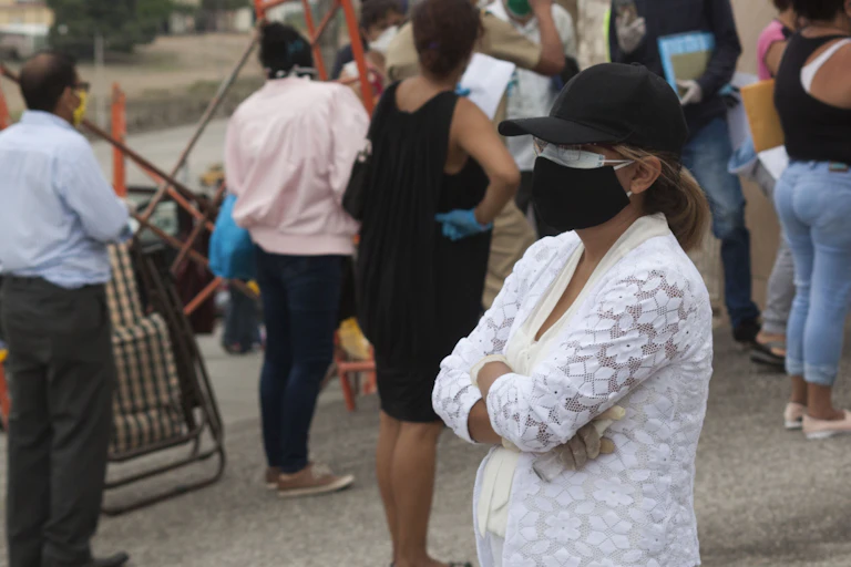 A woman wearing a cloth mask over a medical mask