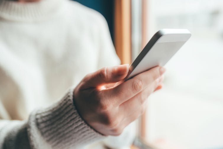 Woman holding smartphone about to make a call