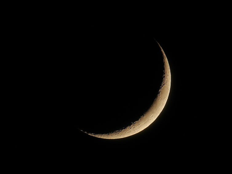 The Moon in a crescent phase.