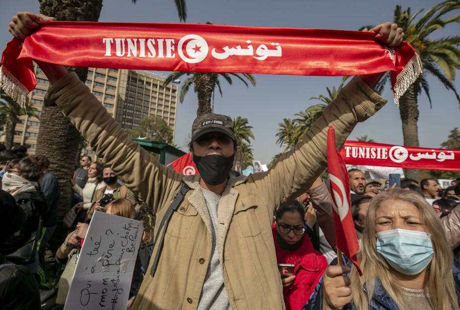 Protestors hold up a "Tunisia" banner