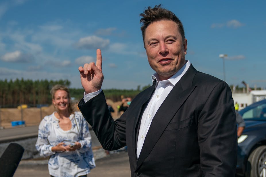 Elon Musk pointing at the sky