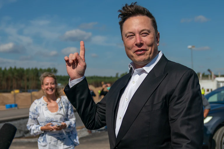Elon Musk pointing at the sky