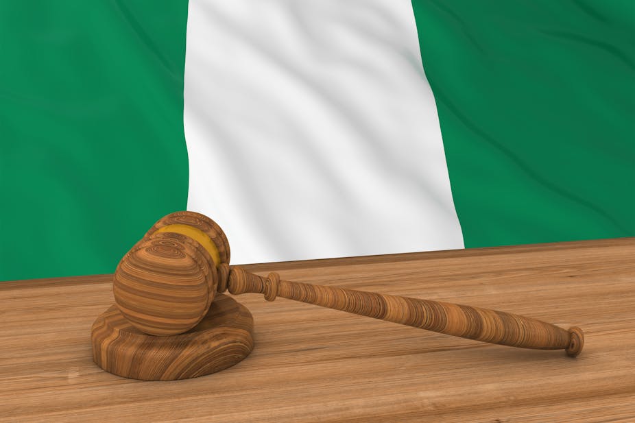 Flag of Nigeria behind a judge's gavel 