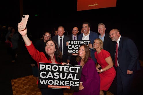 Terri Butler takes a selfie with Anthony Albanese, and several others, carrying signs which read "Protect Casual Workers"