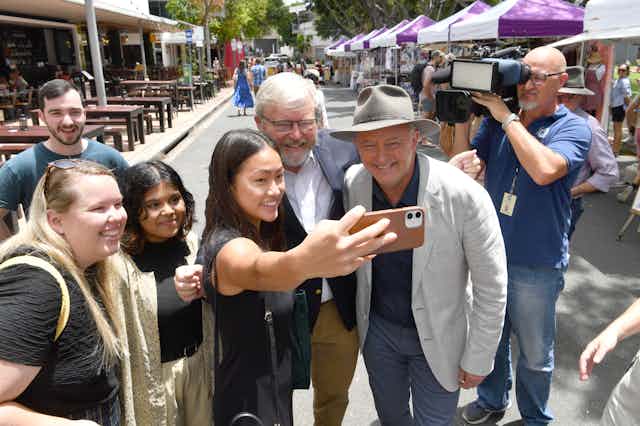 Anthony Albanese campaigns at a Brisbane market with Kevin Rudd.