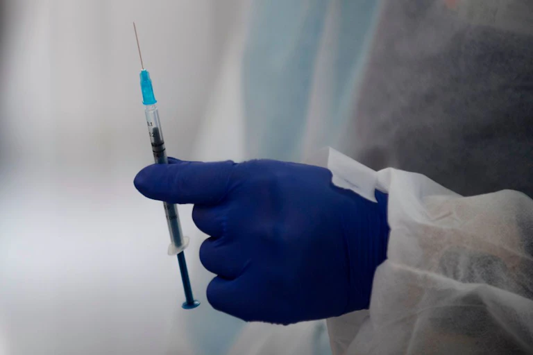 health worker holding a vaccine