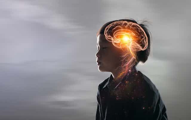 Artist impression of a boy with his brain activity marked in yellow. 