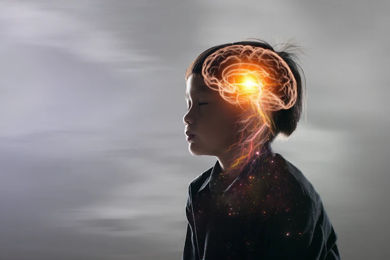 Artist impression of a boy with his brain activity marked in yellow.