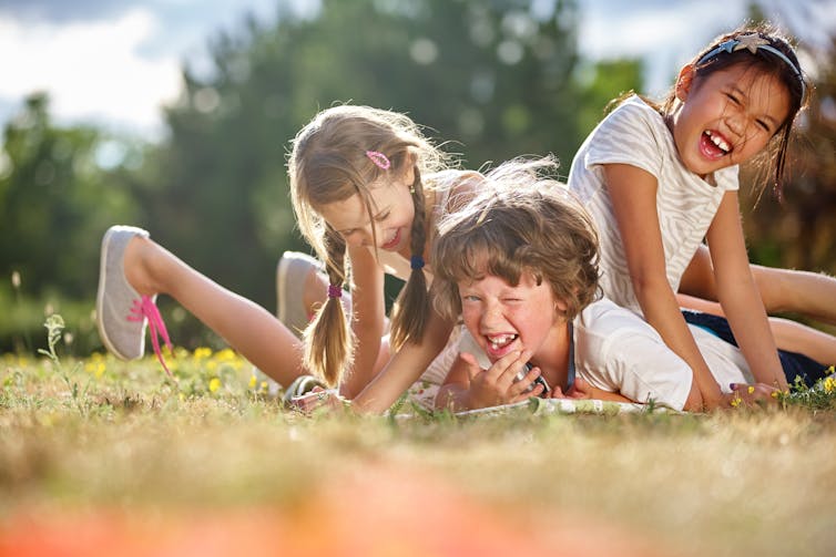 Image of happy children playing and having fun in summer.