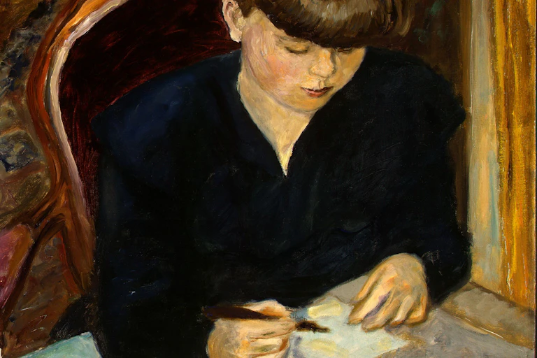 A woman writes a letter.