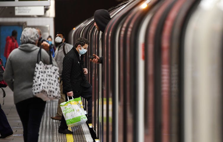 Commuters boarding a London Underground train