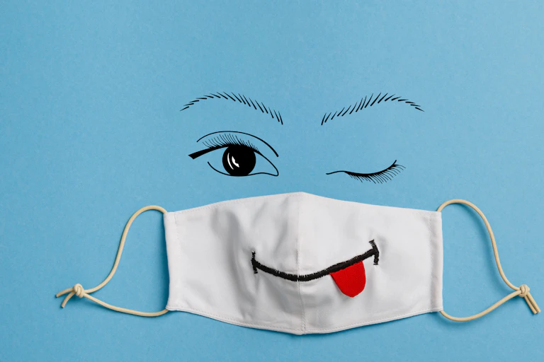 A face mask with a tongue sticking out.