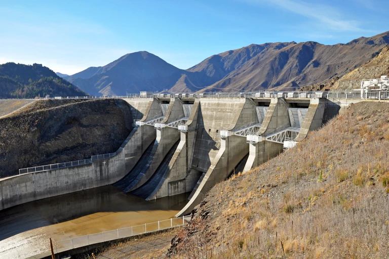 Dam spillway with mountains in background