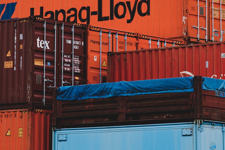 Large shipping containers stacked closely together.