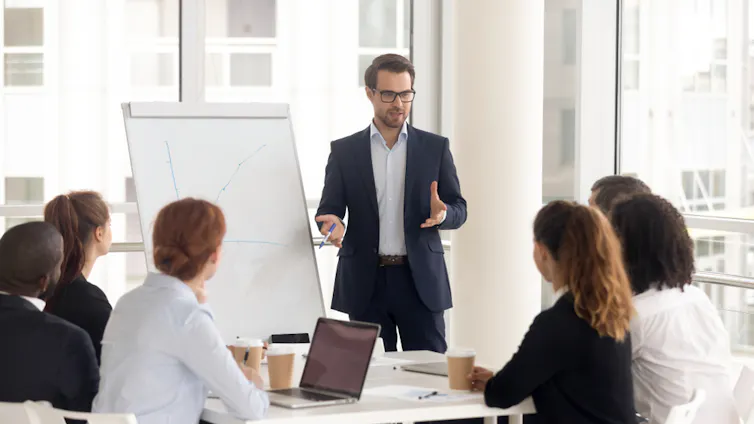 Consultant giving presentation to a small group in a meeting room