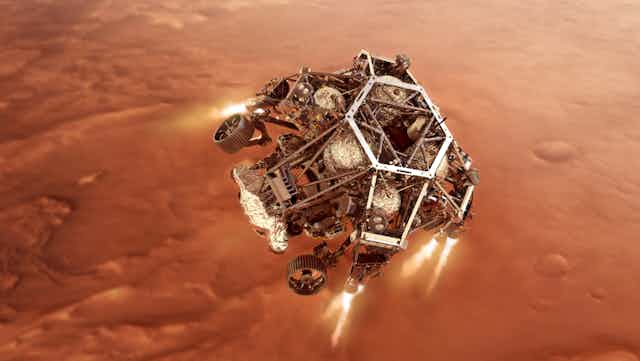 An artist's impression of NASA’s Perseverance rover firing up its descent stage engines as it nears Mars's surface.