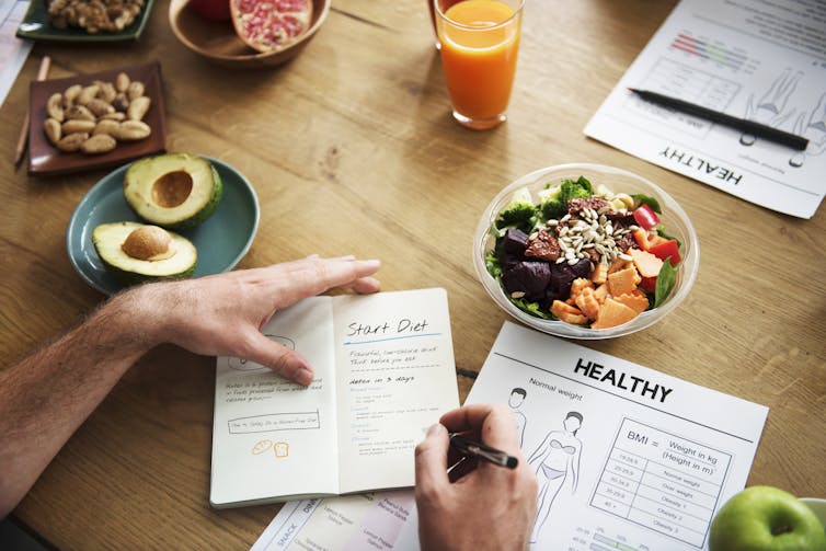 A man fills out a diet plan.