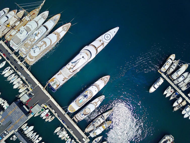 Megayachts in a harbour viewed from above.