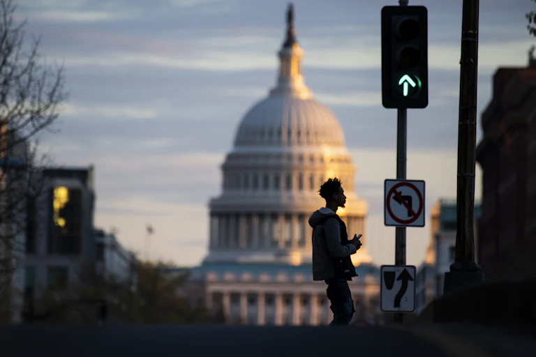 The Capitol dome, with a green traffic light in front of it
