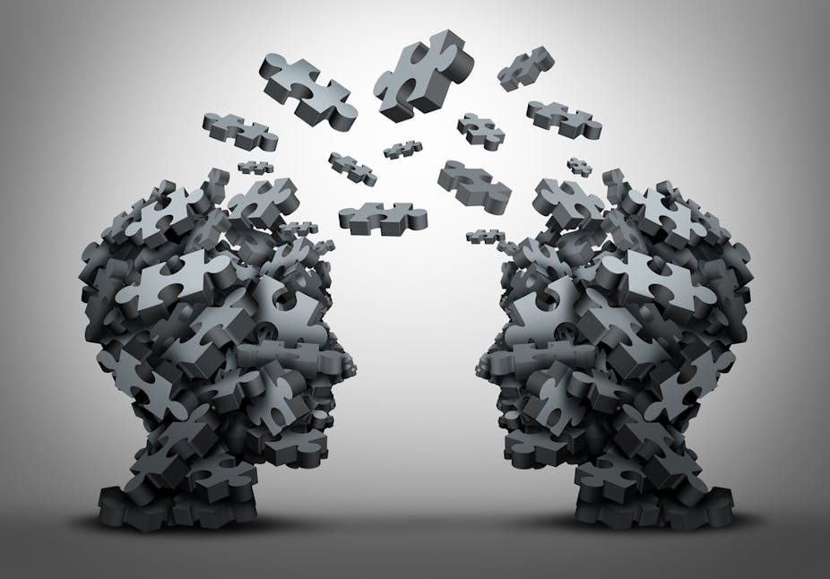 A group of jigsaw puzzle pieces, shaped as two human heads, exchange between the two heads in a 3D concept illustration.