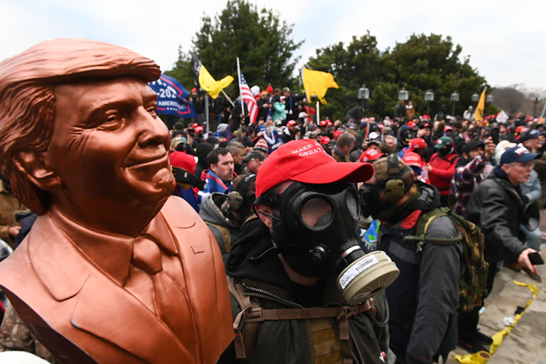 A Donald Trump supporter wears a gas mask.