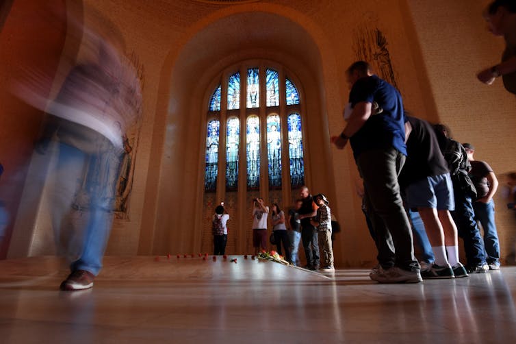 People inspect the tomb of the unknown soldier