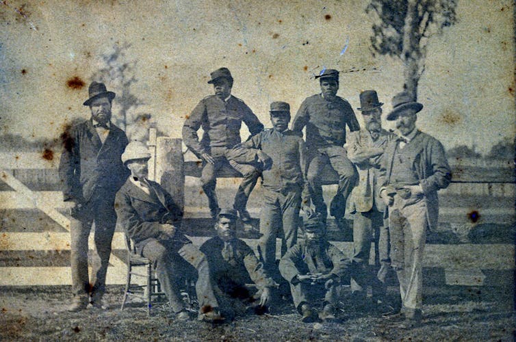 Photograph of nine men.