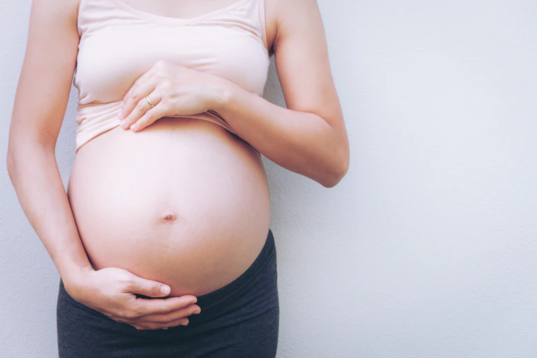Pregnant woman holding belly