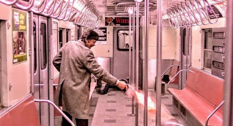 A Man Shoots A Gun On The Subway.