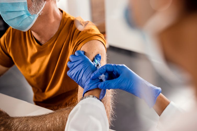 A man receives a vaccination.