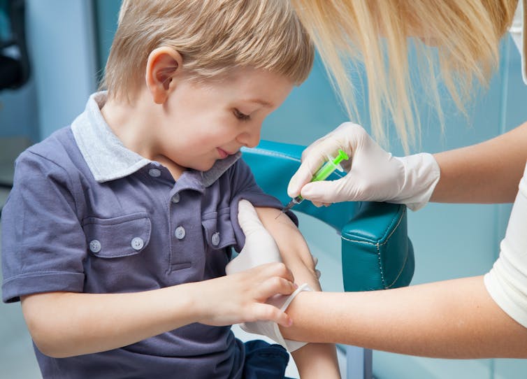 A young boy being vaccinated