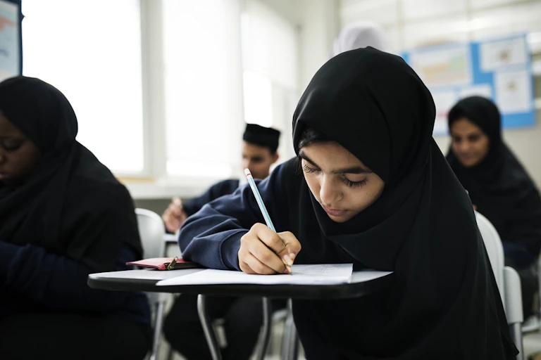 Muslim children studying in a classroom.