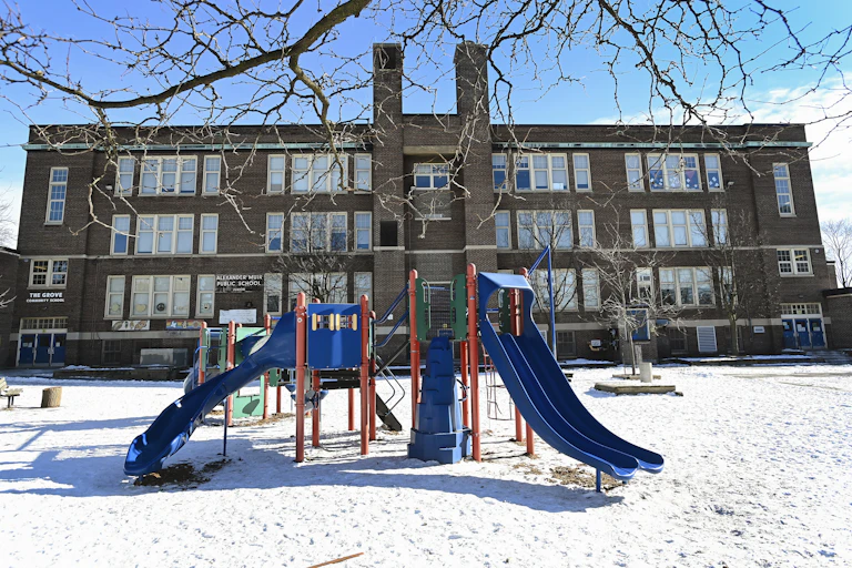 A school in winter, the empty playground is in the foreground.