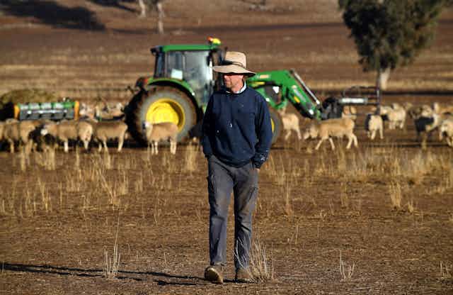 A farmer in a parched field during Australia's latest drought