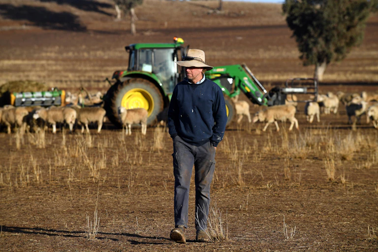A farmer in a parched field during Australia's latest drought