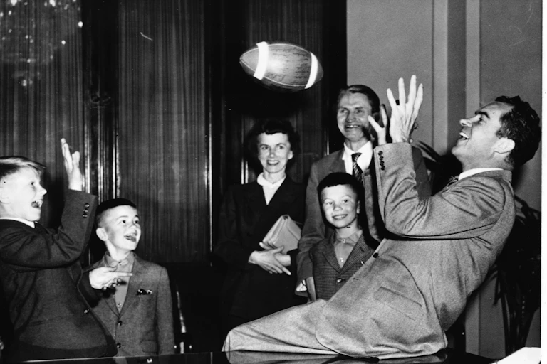 Richard Nixon, tossing a football with boys.