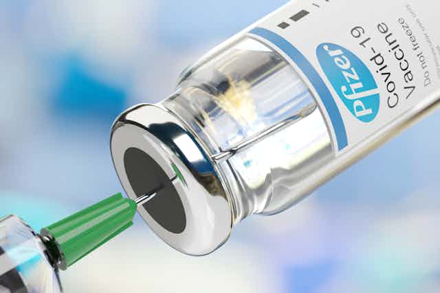 Syringe drawing up Pfizer covid vaccine from vial