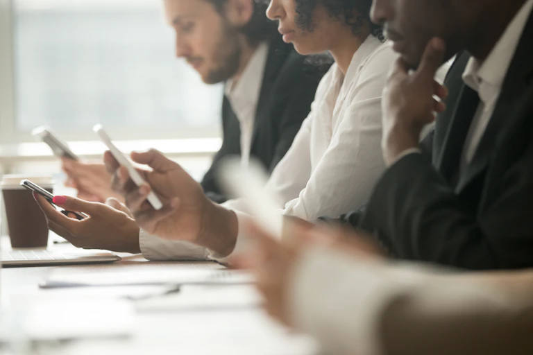 People in an office using smartphones