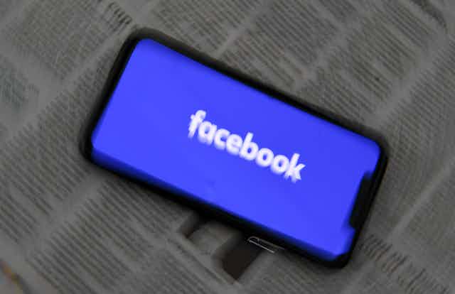 Blurred image of phone with Facebook logo