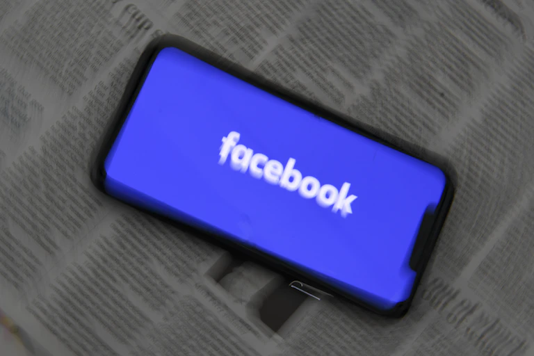 Blurred image of phone with Facebook logo