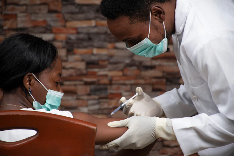 A doctor injects a woman with the COVID-19 vaccine