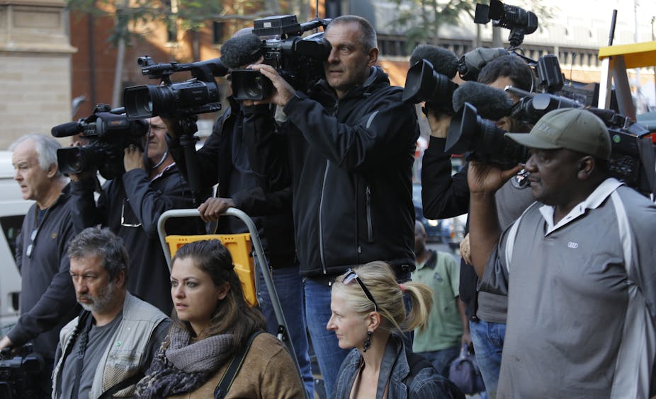 A group of people, some holding television cameras