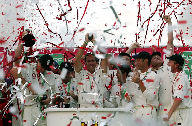 England men's cricket team with captain Michael Vaughan at the centre holding up the Ashes trophy after winning the series against Australia for the first time since 1985.