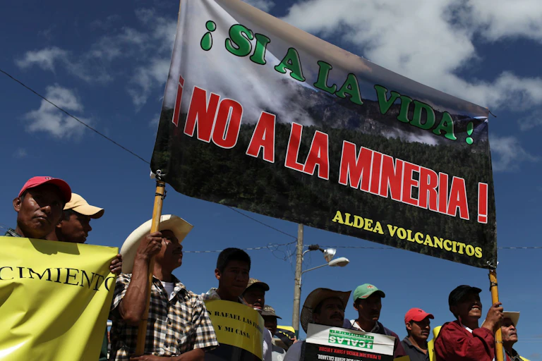 Protesters hold up an anti-mining sign.